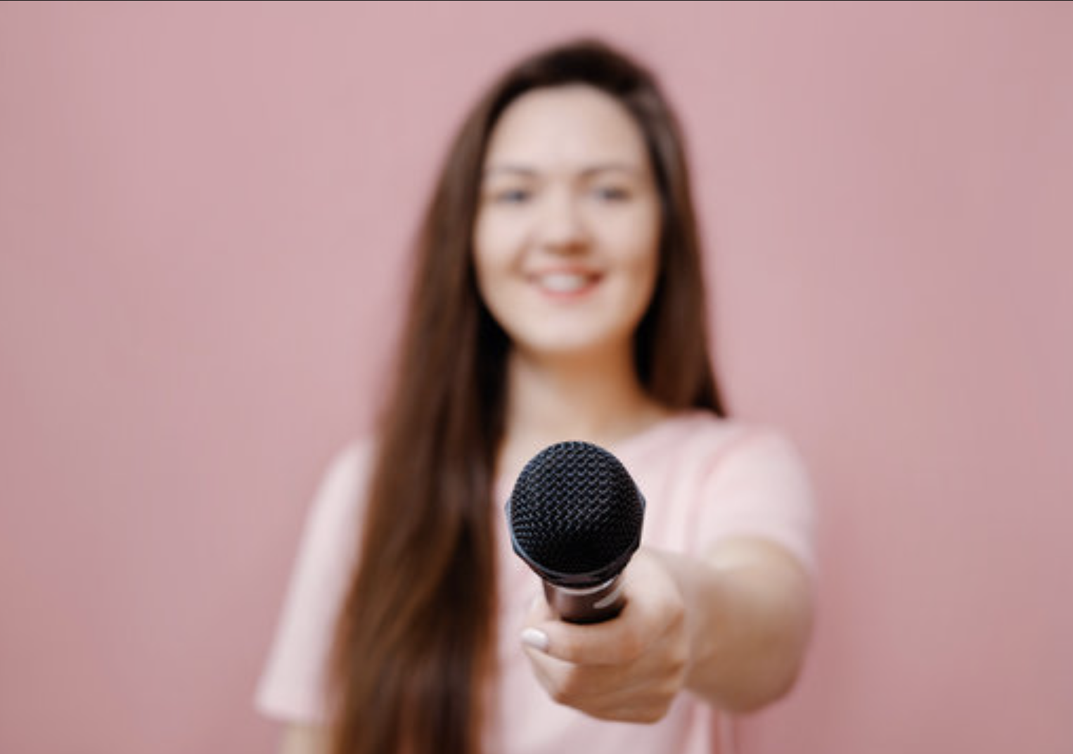 Woman offering microphone graphic on pink background