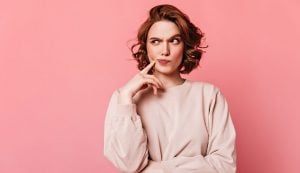 Girl with face asking am I a bad Person? graphic on pink background