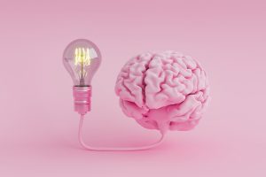 Brain with bulb on pink background