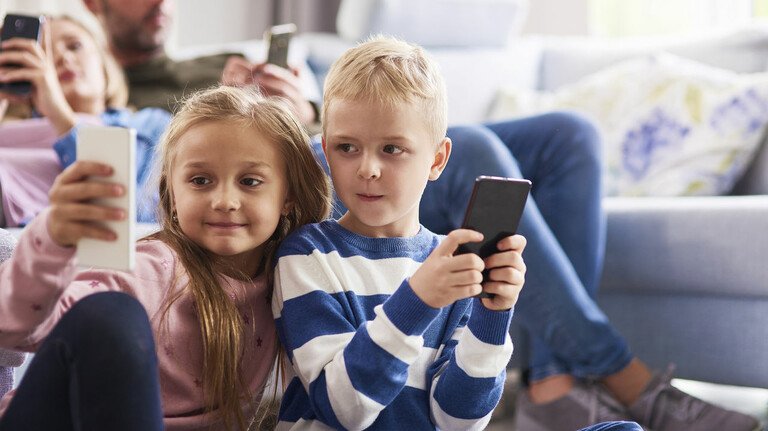 Children with an iPod and an iPhone