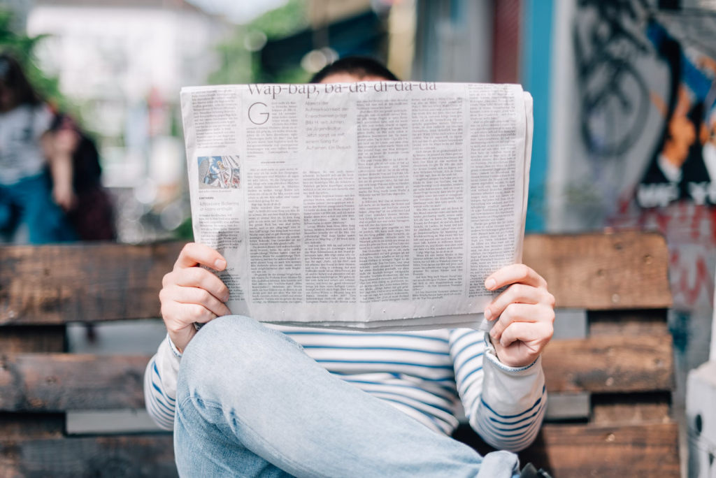 A person reading a newspaper. 