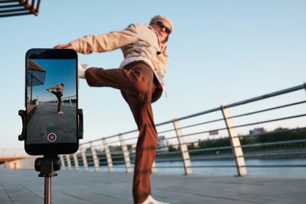 A male hip-hop dancer creating content with his phone