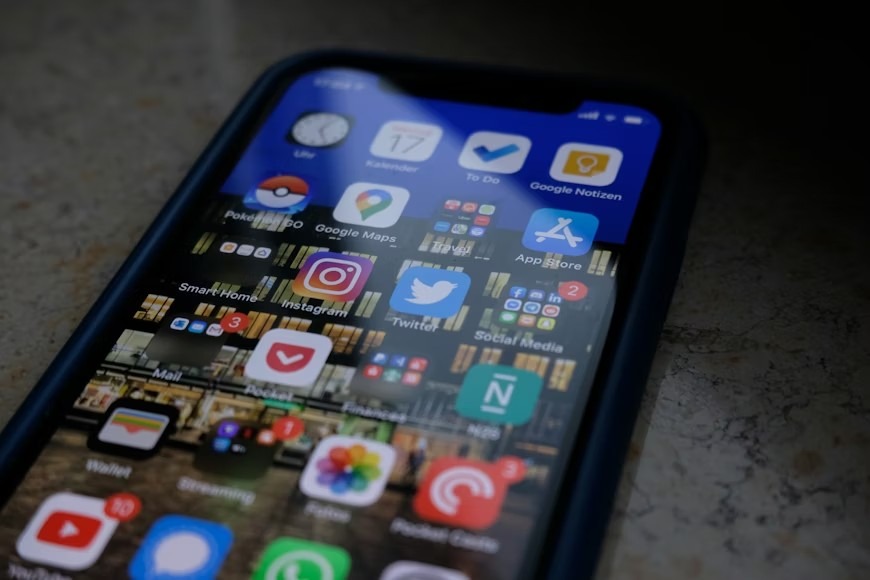 A black iPhone screen displaying several content distribution icons used in the omnipresent content distribution approach.