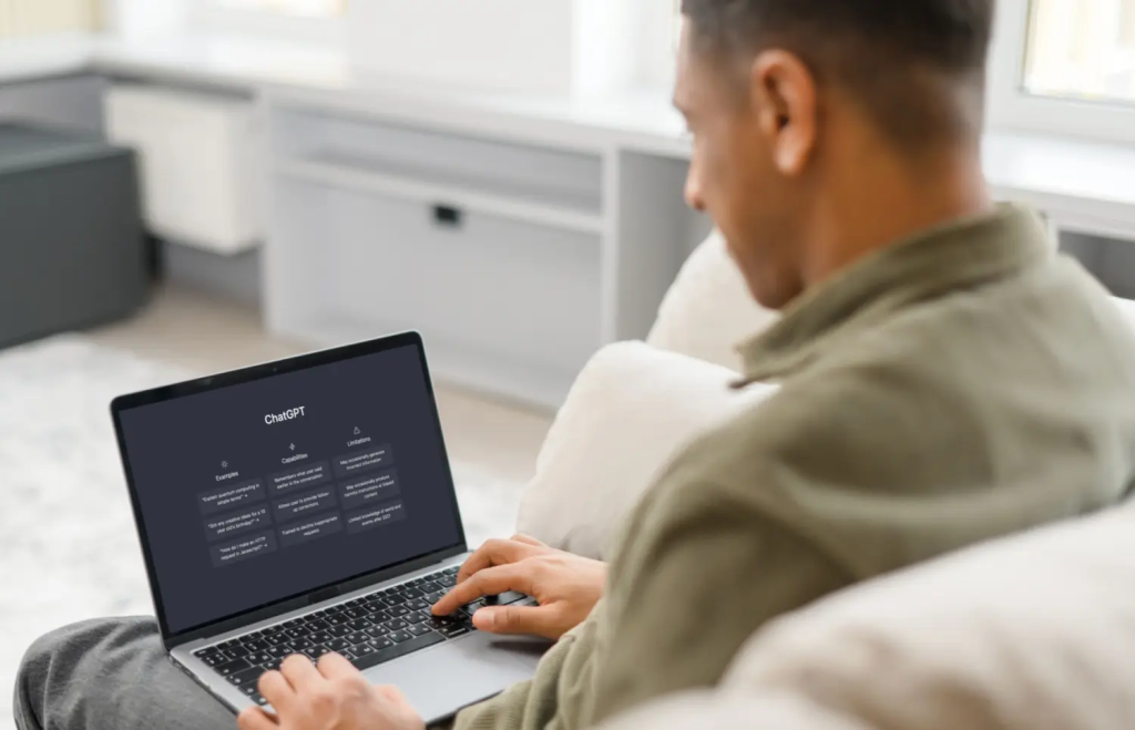 Man browsing the ChatGPT interface on a laptop.