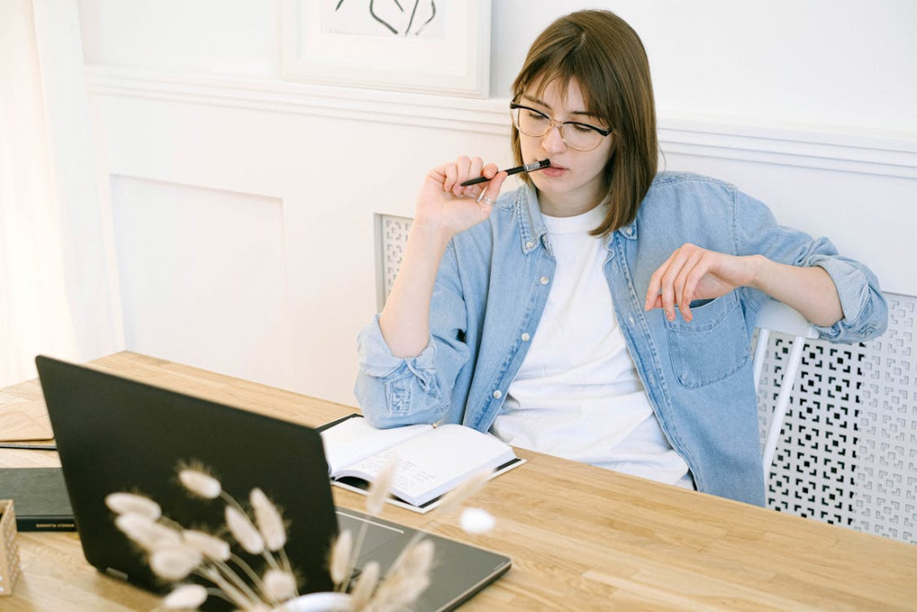 Woman working in a home office, writing a blog post.
