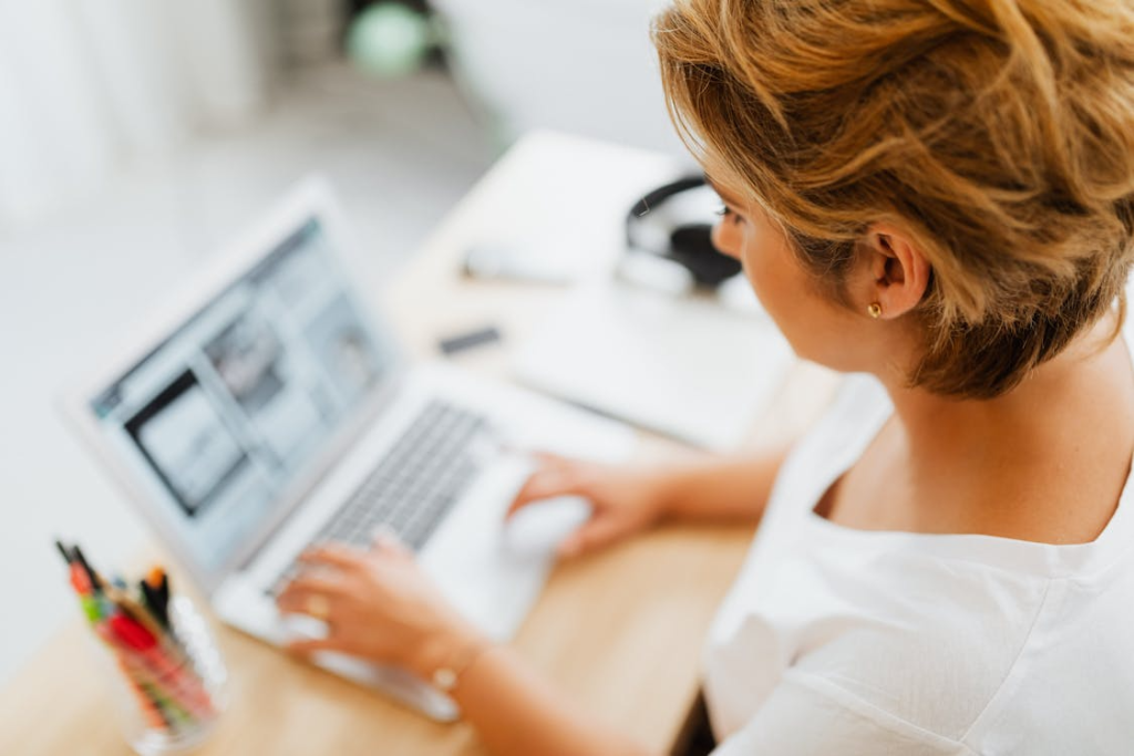 Woman at laptop evaluating SEO recommendations to determine which ones have proven, measurable impact.