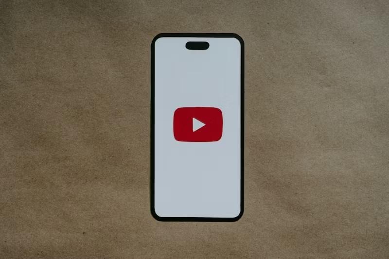 Smartphone displaying the YouTube app logo against a plain background
