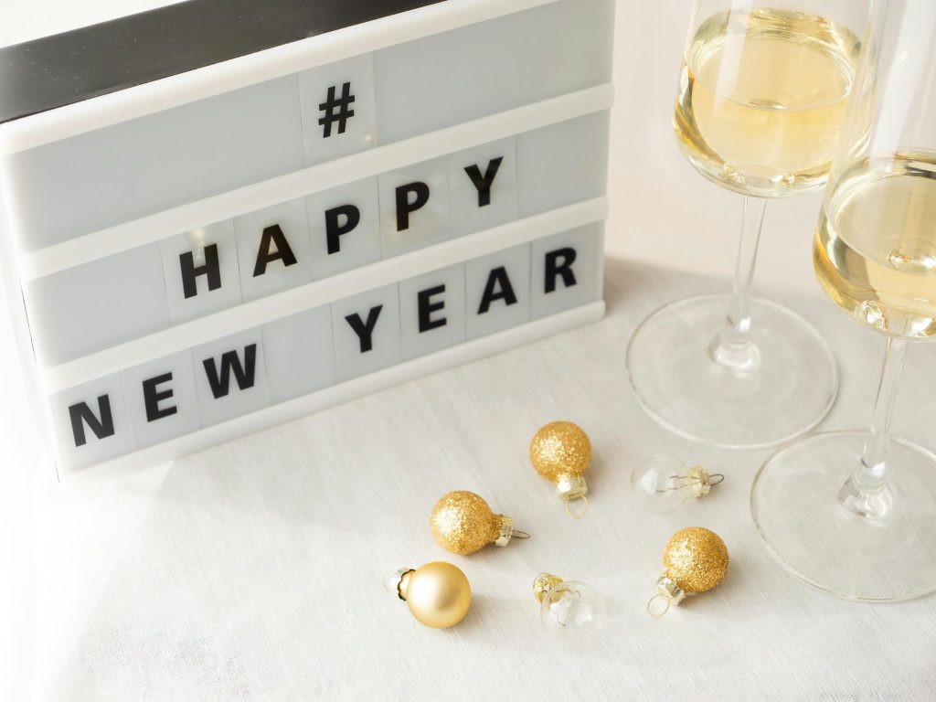 Light-up Happy New Year sign with champagne flutes for January 1 retail promotions