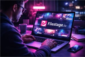 A person operating a computer with the Filestage.io displayed across the screen