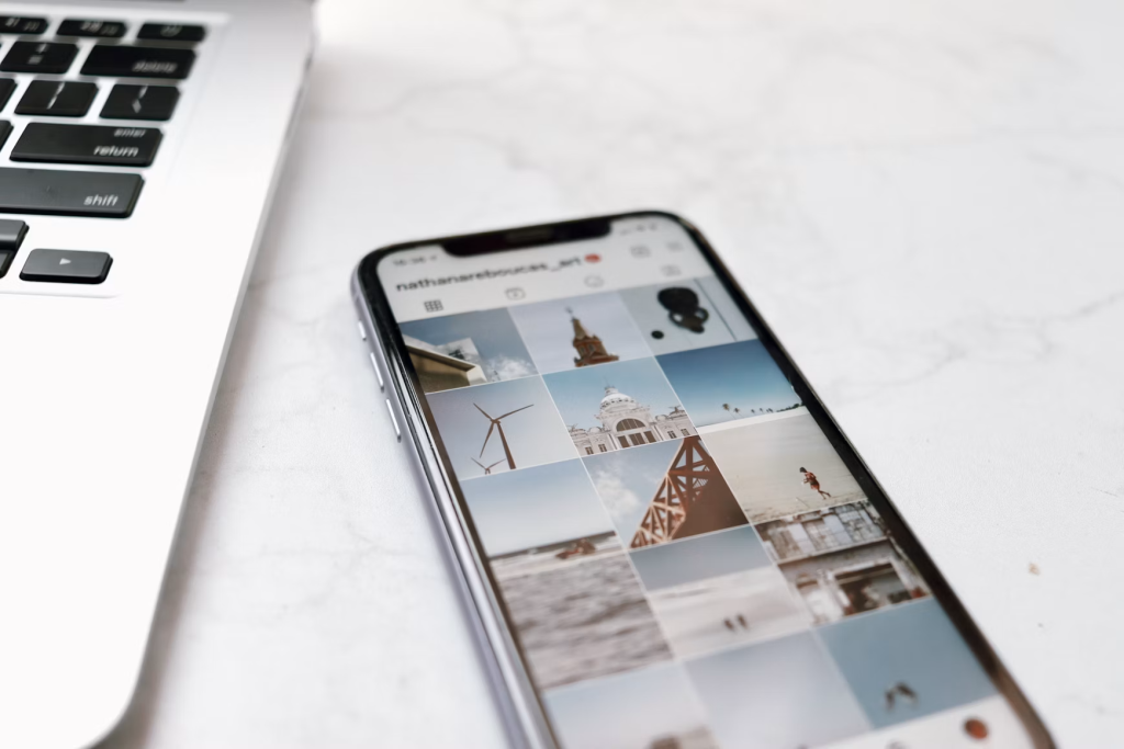 Black Android phone on a white table showing an Instagram feed.