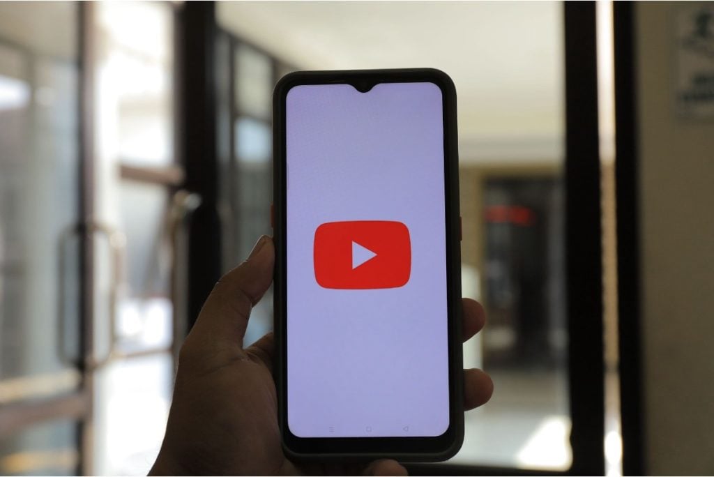 Person opening YouTube on his mobile phone