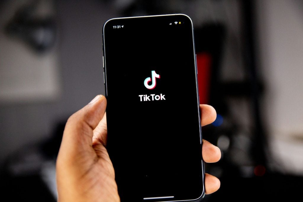 Person opening TikTok on their phone