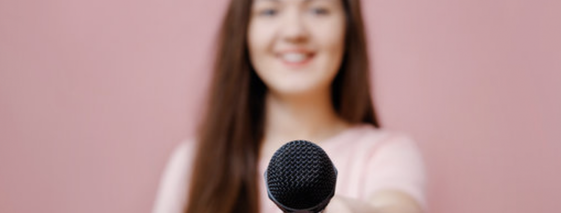 Woman offering microphone graphic on pink background